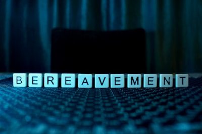 the word bereavement spelled with cubes on a table