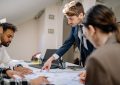 A diverse team engaged in a business meeting, fostering collaboration and teamwork in an office setting.