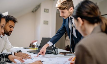 A diverse team engaged in a business meeting, fostering collaboration and teamwork in an office setting.