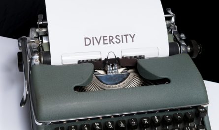 green and white typewriter on white table